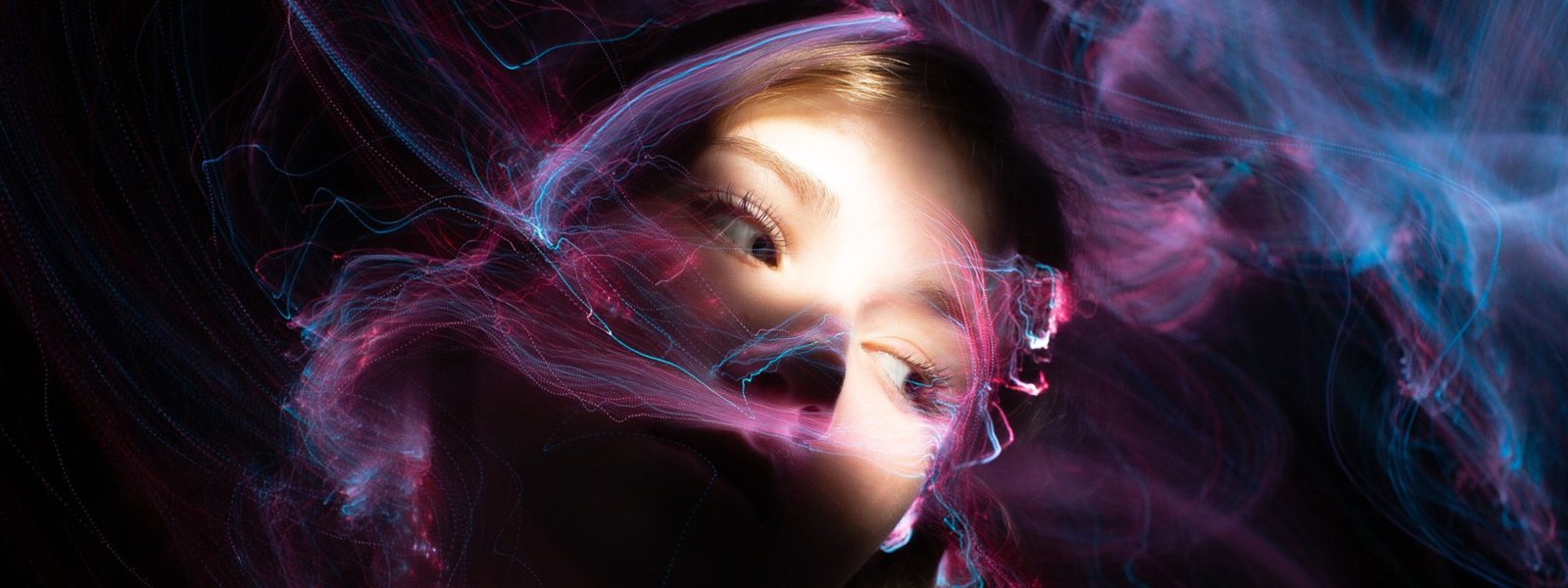 woman with colourful wisps of light