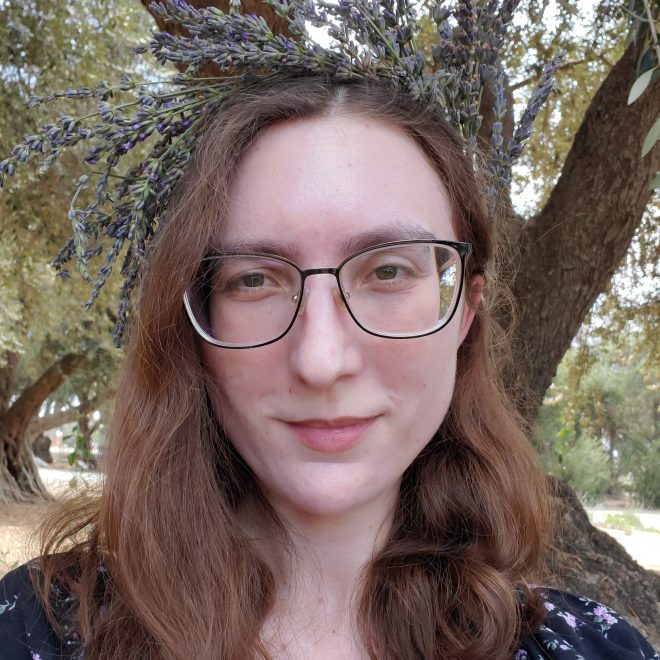 A white woman with glasses and long brown hair