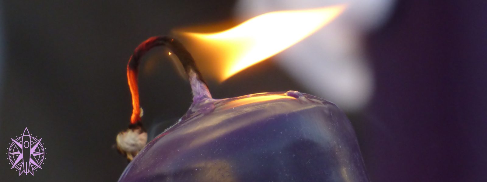 a close up of a burning purple candle