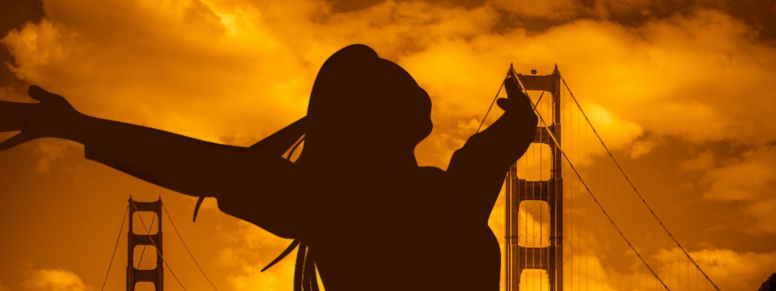 silhouette of a woman with her arms raised against a backdrop of the golden gate bridge