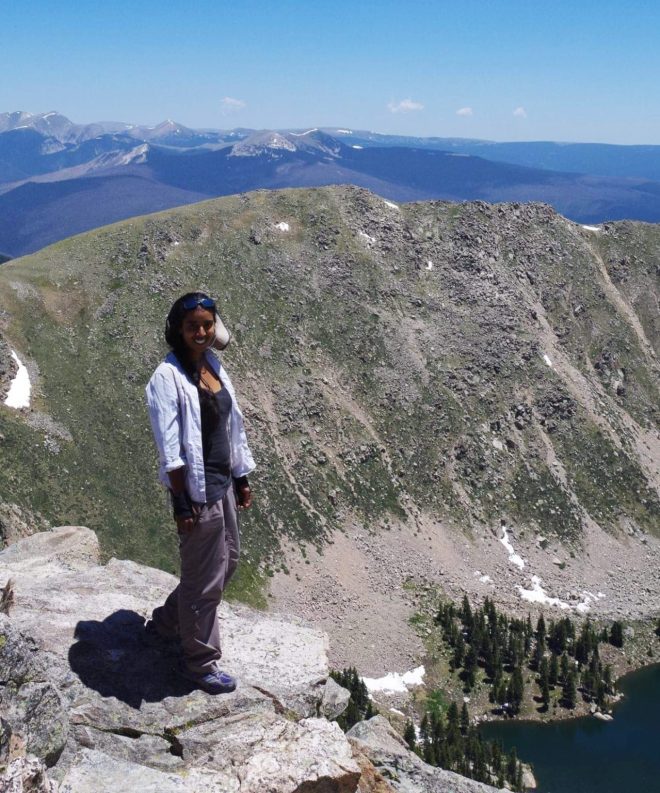 Tehnuka standing on the rim of a volcano